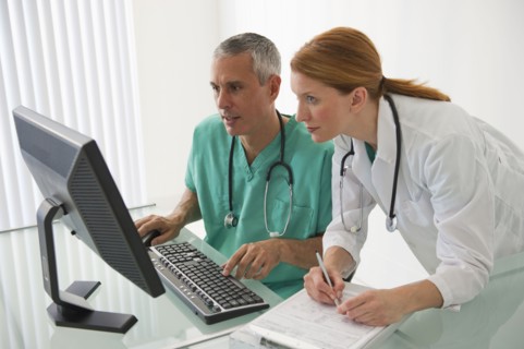 Healthcare professionals looking at computer.