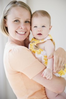 Mother holding her baby daughter. Photo : Jamie Grill