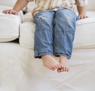 Young boy sitting on couch.