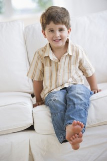 Young boy sitting on couch.