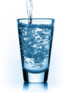 Water being poured in glass. Photo : David Arky