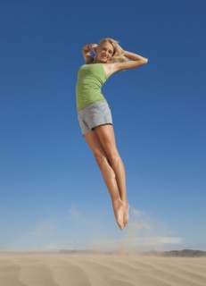Woman jumping in the desert. Photo. Mike Kemp