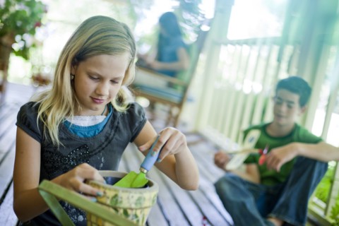 Young girl potting a plant. Photo. Tim Pannell