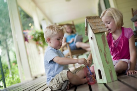 Brother and sister painting birdhouse together. Photo : Tim Pannell