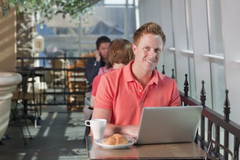 Man sitting on patio at cafe. Photo : Dan Bannister