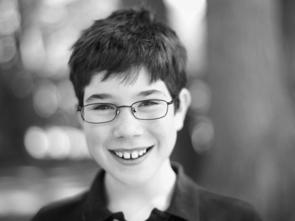 Cute child wearing reading glasses. Photo : John Kelly