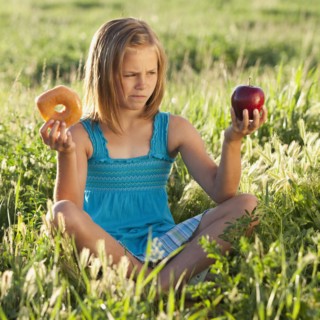 Young girl making food choice. Photo. Mike Kemp