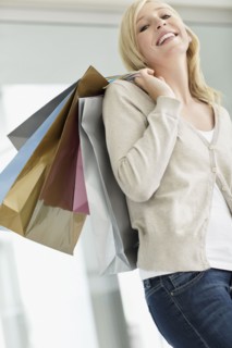 Attractive woman holding shopping bags. Photo. momentimages