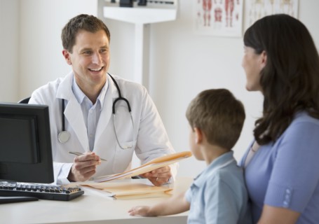 Doctor talking to woman and her son.