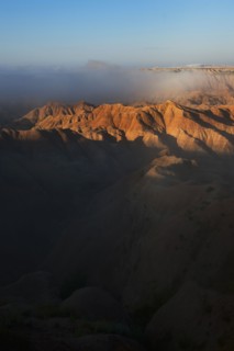 USA, South Dakota, Mountains in morning fog in Badlands National Park.