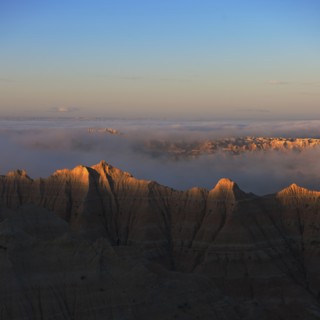 USA, South Dakota, Mountains in morning fog in Badlands National Park.