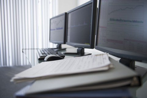 Close up of computer monitors in office.