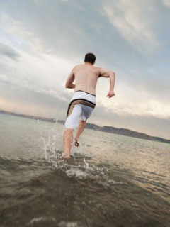 Man running on beach.