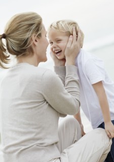 Boy (4-5) playing on beach with mother. Photo : Momentimages