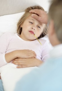 Grandfather tending granddaughter (10-11) lying in bed with thermometer in mouth. Photo :
