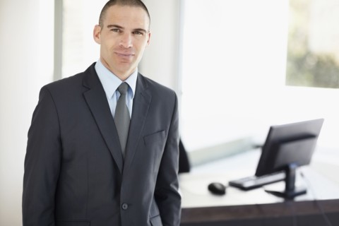 Portrait of businessman in office environment. Photo : Momentimages