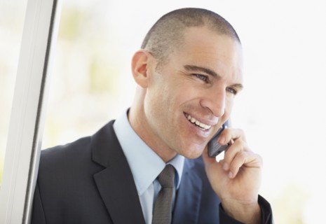 Businessman using mobile phone. Photo : Momentimages