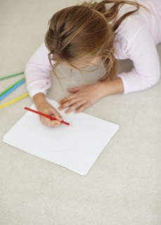 Girl (10-11) drawing. Photo : Momentimages