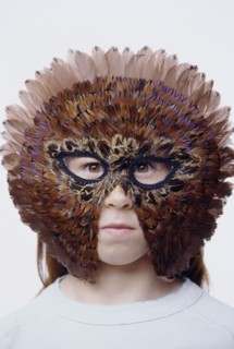 Child wearing a feather mask. Photo : Fisher Litwin