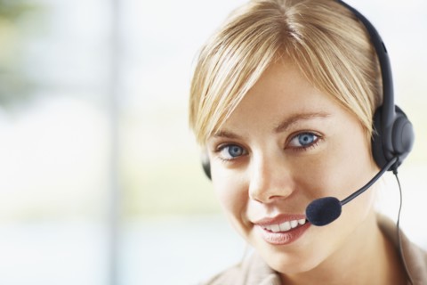 Portrait of young female customer service representative. Photo : Momentimages