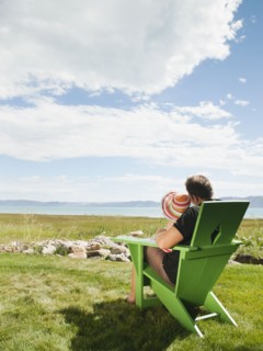 Father and daughter sitting (2-3) on chair and looking at view.