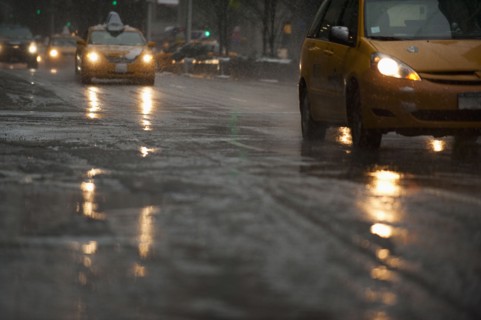 USA, New York, New York City, Traffic on street in snow, dusk.
