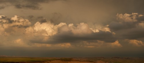 USA, South Dakota, Badlands National Park, Clouds above mountains at sunset.