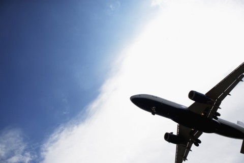 Silhouette of flying airplane. Photo : fotog