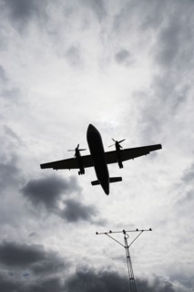 Silhouette of flying airplane. Photo : fotog