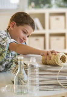 Boy (10-11) sorting garbage at home. Photo : Daniel Grill