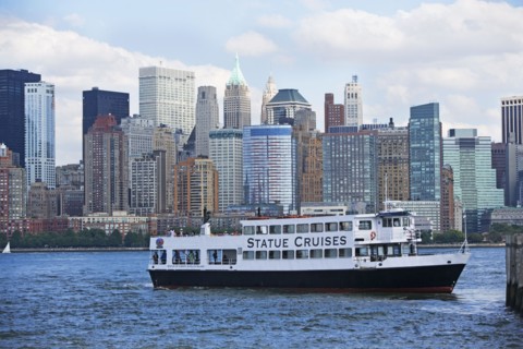 USA, New York State, New York City, Cruise ship on Hudson River, Battery Park in background. Photo