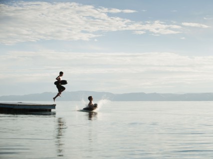 Boys (10-11,12-13) jumping from raft.