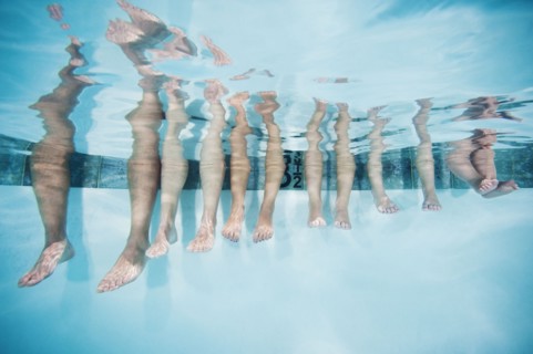 Family with four kids (12-18months, 4-5,6-7,8-9) on swimming pool.