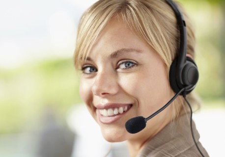 Portrait of young female customer service representative. Photo : Momentimages