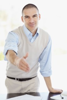 Mid adult man offering hand for handshake. Photo : Momentimages
