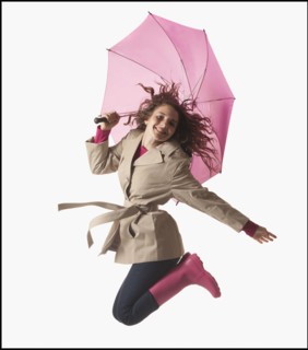 Woman with umbrella jumping on white background. Photo : Mike Kemp