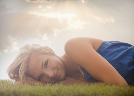 Young girl (16-17) lying on grass. Photo : Mike Kemp