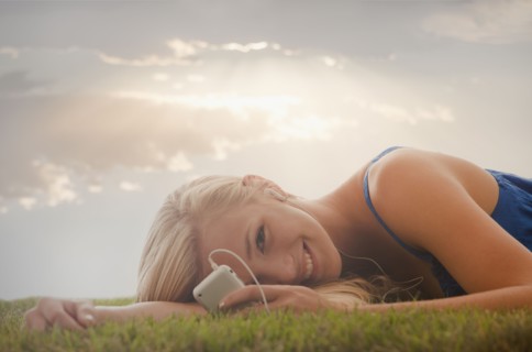 Young girl (16-17) lying on grass. Photo : Mike Kemp