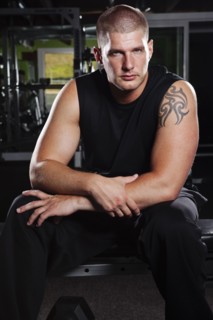 Mad adult man sitting in gym. Photo : Take A Pix Media