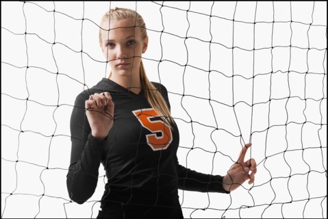 Young girl (16-17) playing volleyball. Photo : Mike Kemp