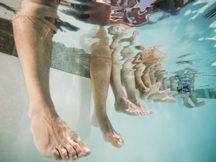 Family with four kids (12-18months, 4-5,6-7,8-9) on swimming pool.