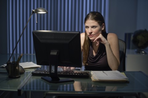 Woman working late in office.
