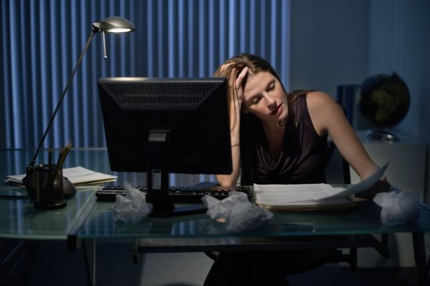 Woman working late in office.