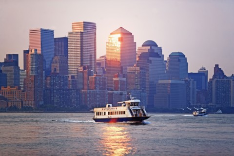 USA, New York State, New York City, Ferry on river and World Financial Center at sunset. Photo :