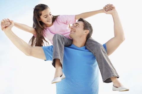 Father carrying daughter (10-11) on back. Photo : Momentimages