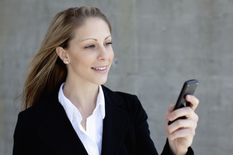 Businesswoman using mobile phone. Photo : Johannes Kroemer