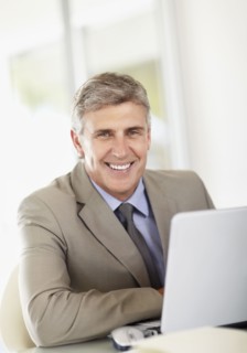 Portrait of businessman with laptop. Photo : Momentimages