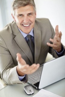 Portrait of businessman with laptop. Photo : Momentimages