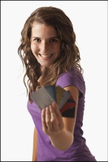 Young woman showing credit cards. Photo : Mike Kemp