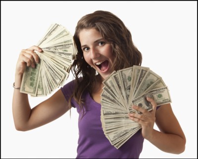 Young woman holding fanned out banknotes. Photo : Mike Kemp